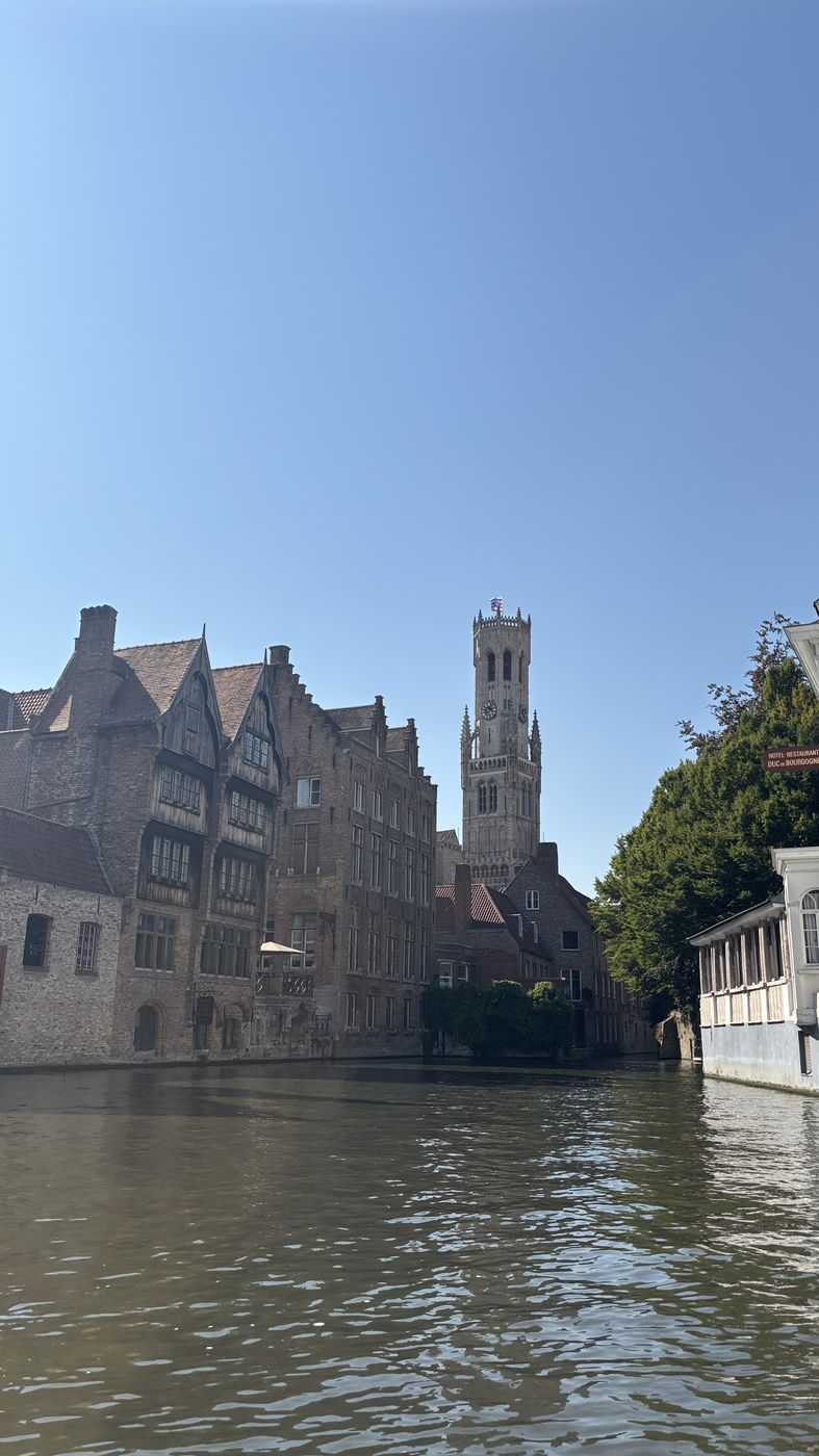 The belfry rising over a canal