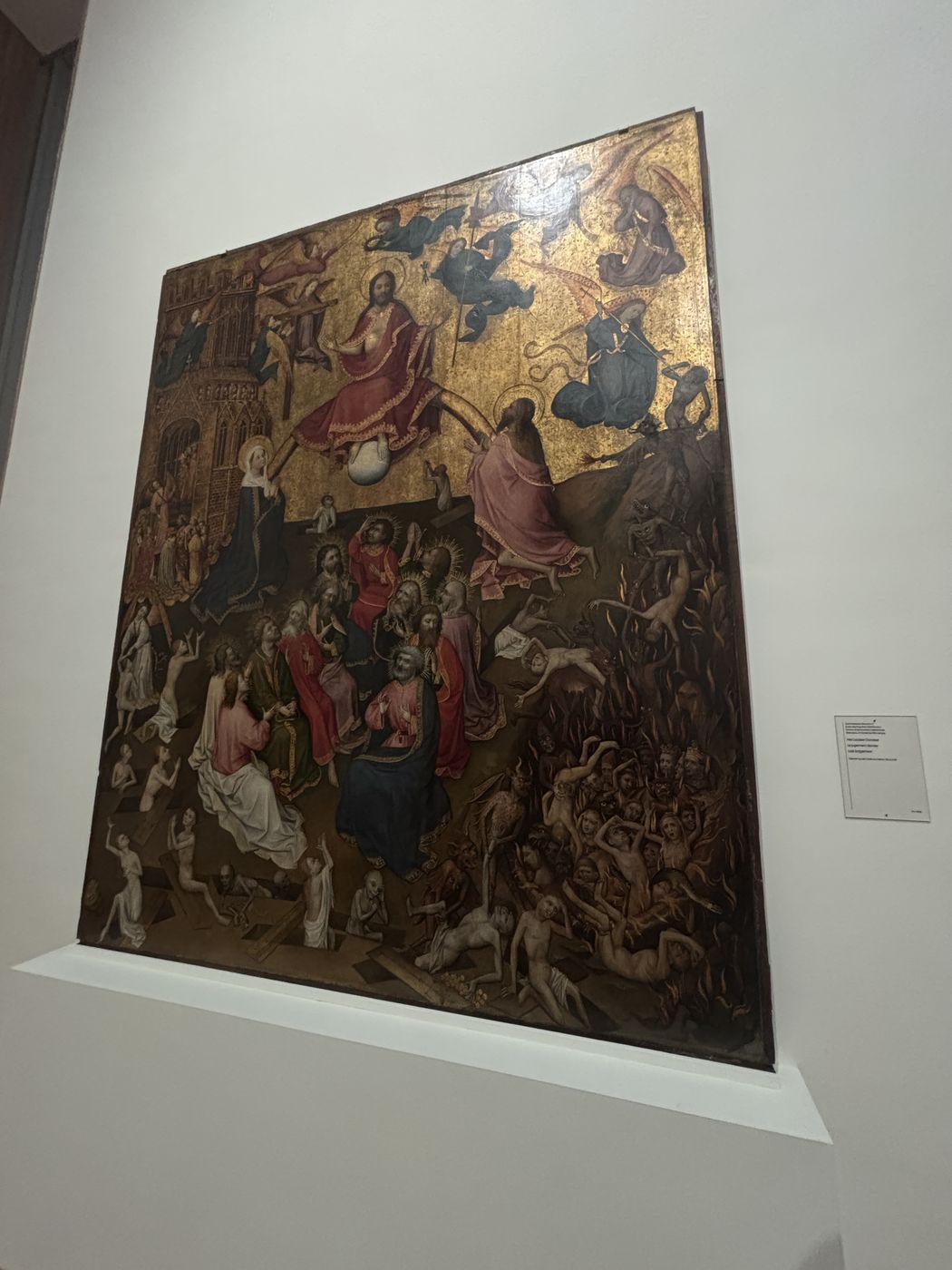 A crowded medieval panel painting of the Last Judgment
