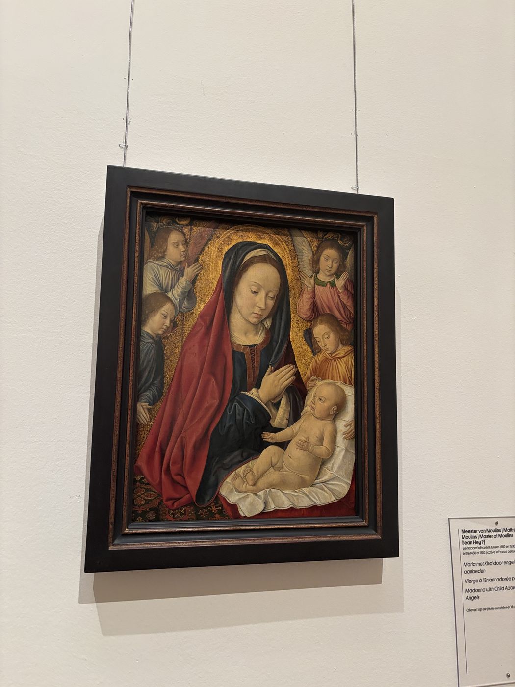 A Madonna and Child panel with angels