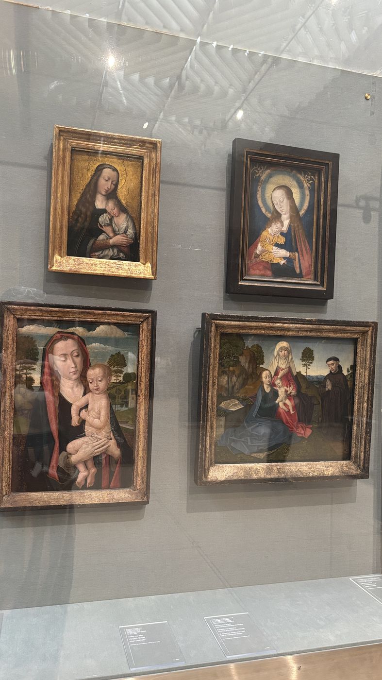Four small devotional panels on a grey wall