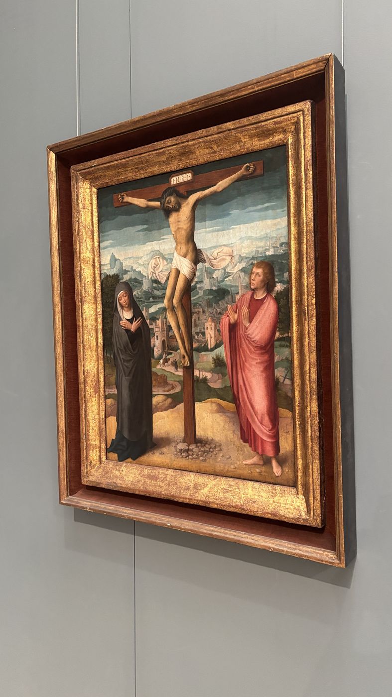 A small Crucifixion panel in a gold frame