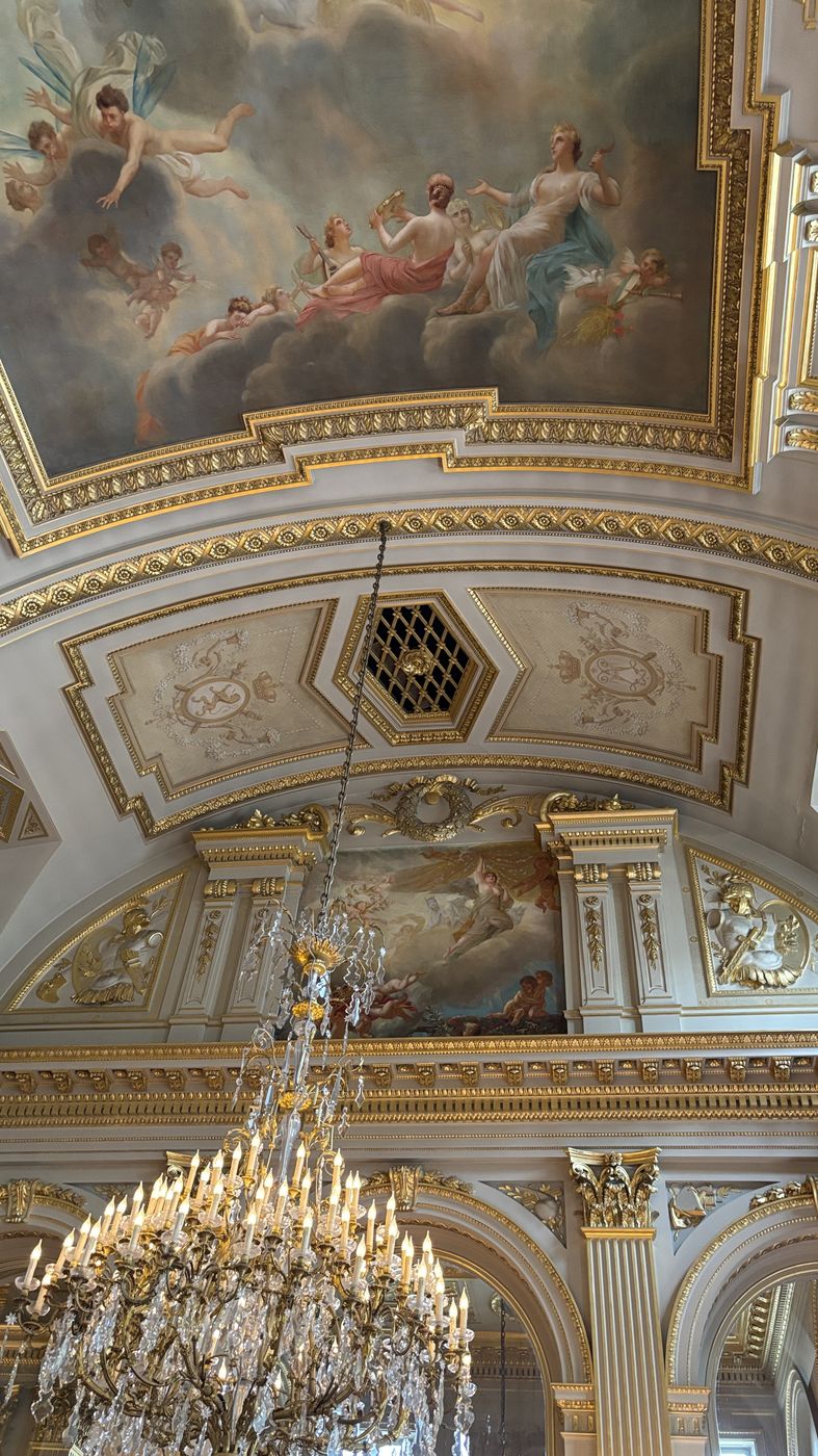 Gilded ceiling with a painted fresco and chandelier