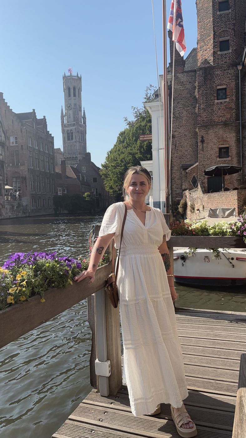 Me on a canal-side deck with the belfry behind me