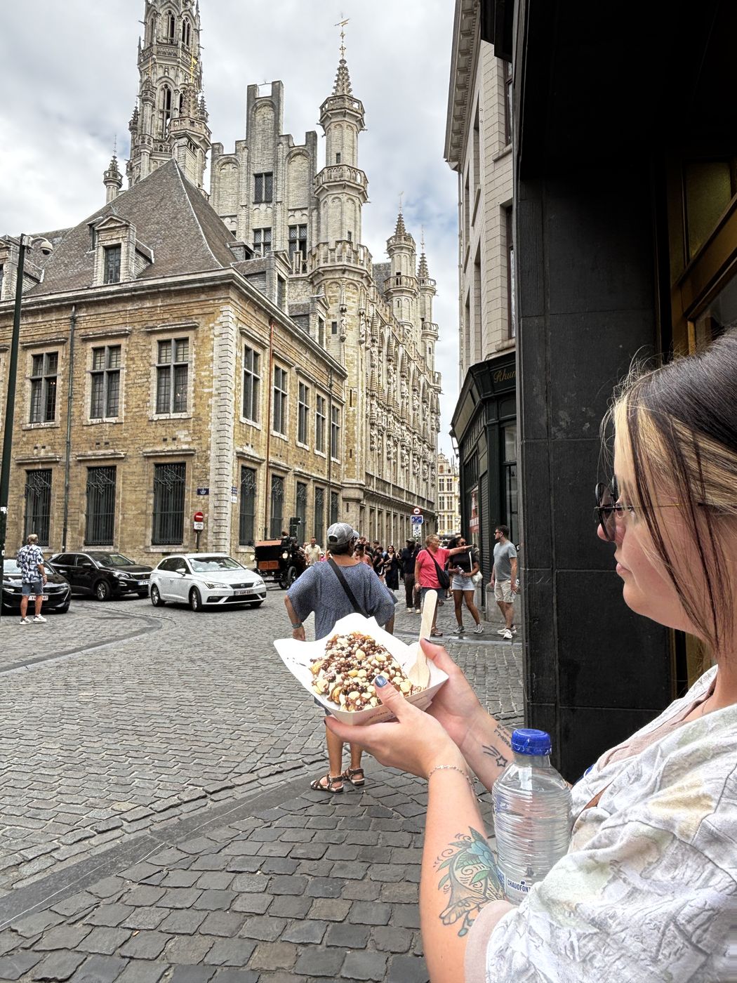 Me holding a waffle on the Grand Place in Brussels