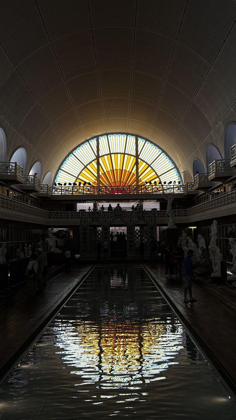 The stained-glass sunburst window over the pool at La Piscine