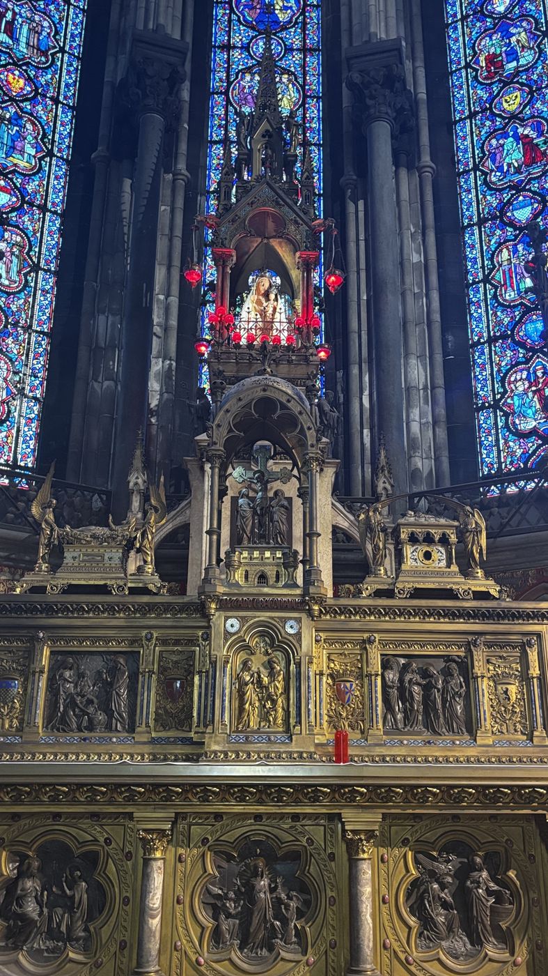 Gilded altar under a stained glass window