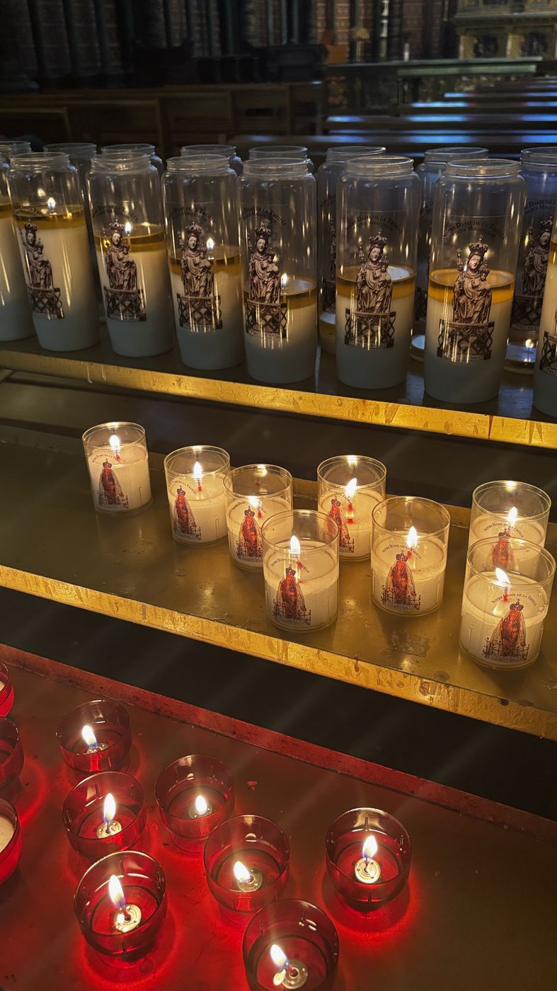 Rows of lit prayer candles