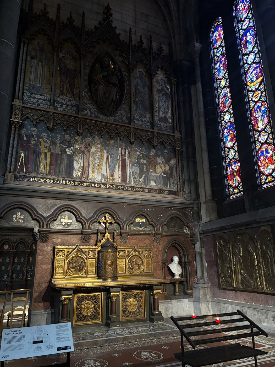 A side chapel with painted walls and stained glass